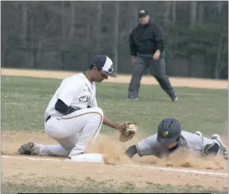  ?? STAFF PHOTO BY MICHAEL REID ?? St. Mary’s first baseman Anthony Cangelosi tries to tag out Randolph-Macon baserunner Ryan Duphorn on a pickoff play in Tuesday’s contest. The Seahawks fell 13-1.