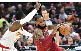  ??  ?? CLEVELAND CAVALIERS forward LeBron James (#23) drives against Atlanta Hawks guard Dennis Schroder (#17) in the first quarter at Quicken Loans Arena.