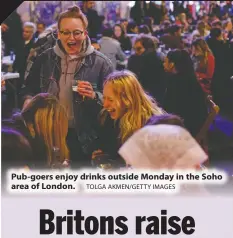  ?? TOLGA AKMEN/GETTY IMAGES ?? Pub-goers enjoy drinks outside Monday in the Soho area of London.