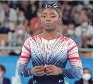  ?? GREGORY BULL/AP ?? Simone Biles waits to compete on the balance beam during the artistic gymnastics women’s apparatus final at the Summer Olympics on Aug. 3 in Tokyo.