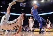  ?? John Bazemore / AP ?? Georgia Tech starting point guard Jose Alvarado (10) falls to the floor after battling Duke forward Javin DeLaurier (12) during Sunday’s game in Atlanta. Alvarado injured his arm and left the NCAA basketball game. ATLANTA