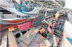  ??  ?? DAMAGE REPORT: Officials inspect the wrecked commuter boat at Wat Thep Leela pier.