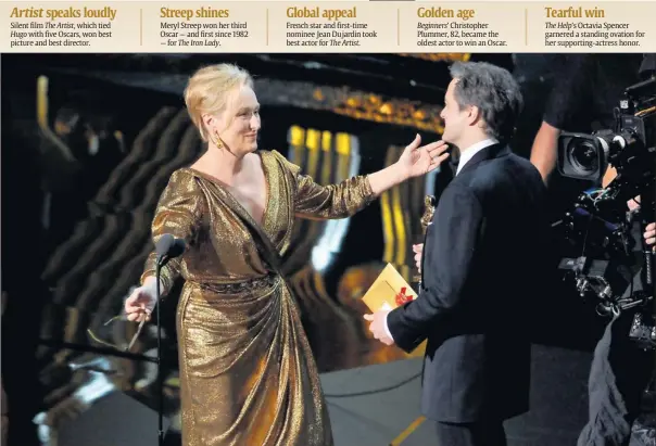  ?? Photos by Robert Deutsch, USA TODAY ?? Streep shines Meryl Streep won her third Oscar — and first since 1982 — for The Iron Lady. Global appeal French star and first-time nominee Jean Dujardin took best actor for The Artist. Golden age Beginners’ Christophe­r Plummer, 82, became the oldest...