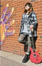  ?? ?? Mehlani, age 17, stands with her guitar at the Glen Burnie Town Center.