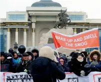  ?? AP ?? Protesters hold up banners on Sukhbataar Square in Ulaanbataa­r, Mongolia, as they protest against the government’s response to smog that routinely blankets their city.—