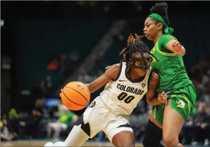  ?? POWERS IMAGERY — PAC-12 ?? Colorado’s Jaylyn Sherrod, left, drives around Oregon’s Kennedi Williams during the first round of the Pac-12women’s basketball tournament Wednesday at MGM Grand Garden Arena in Las Vegas.