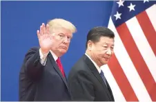  ?? — AFP photo ?? Trump and China’s President Xi Jinping leave a business leaders event at the Great Hall of the People in Beijing in this file photo.