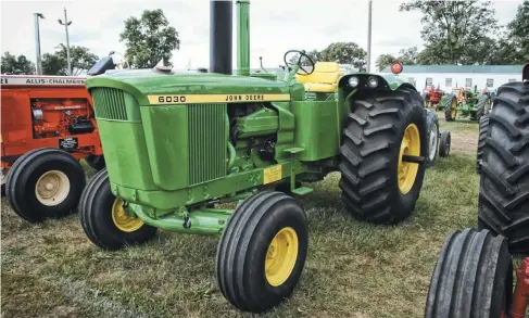  ??  ?? Gale Long’s 1972 6030 standard was fresh out of the restoratio­n shop when it was shot at the 2020 Tri-state Show at Portland, Indiana. It’s unusual in having an adjustable front axle rather than the solid one, which was a choice. There were actually two adjustable fronts, the regular width unit as shown, and an extra wide one for special applicatio­ns. It’s wearing standard-sized rubber, 11.00-16s up front and 24.5-32s in back. It has the full height dust shields and rounded, full-width fenders and the operator’s station is mounted from the rear. Don’t mind the “1973” tag on it. It has a serial number lower than 33550 and according to the published serial number ranges, that falls into the 1972 production range.