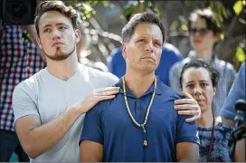  ?? ELIZABETH FLORES / STAR TRIBUNE ?? Don Damond (center) stands with his son, Zach, on Monday as he makes a statement to the media Monday in Minneapoli­s after his fiancé, Justine Damond, was shot to death Saturday night by a city police officer.