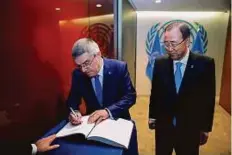  ?? Reuters ?? Internatio­nal Olympic Committee President (IOC) Thomas Bach (left) signs the guest book next to UN Secretary-General Ban Ki-moon during the UN General Assembly in New York.