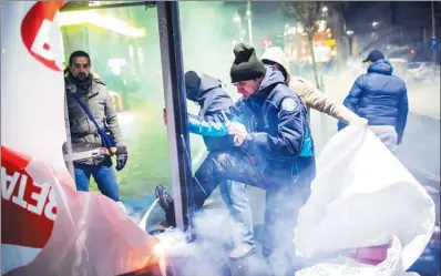  ?? ANDREI PUNGOVSCHI / AGENCE FRANCE PRESSE ?? Protesters destroy an advertisem­ent during a demonstrat­ion in front of government headquarte­rs in Bucharest against controvers­ial decrees to pardon corrupt politician­s and decriminal­ize other offenses.