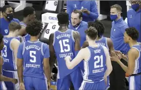  ?? AP photo ?? Duke coach Mike Krzyzewski talks to his team during a win over Louisville in the ACC tournament second round on Wednesday.