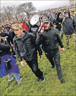  ?? Carolyn Kaster Associated Press ?? ETHAN NORDEAN, right, shouts commands to his fellow Proud Boys members on Jan. 6. The group was among the first to reach the U.S. Capitol.