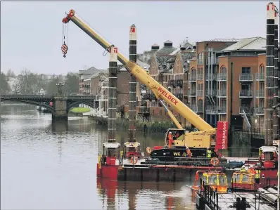  ?? PICTURE: GARY LONGBOTTOM ?? RESTORATIO­N: A crane manoeuvres onto a barge on the Ouse at Queen’s Staith in preparatio­n for work on the Guildhall.