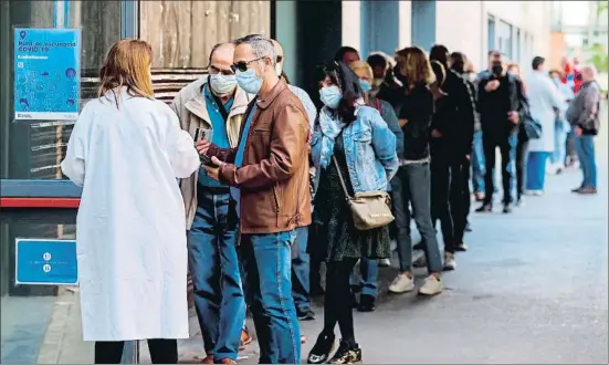  ?? QUIQUE GARCIA / EFE ?? Decenas de personas, ayer, en la cola para recibir el fármaco de Astrazenec­a en el centro de vacunación UB Raval, en Barcelona
