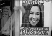  ?? ASSOCIATED PRESS ?? A POSTER FOR MISSING University of Iowa student Mollie Tibbetts hangs in the window of a local business Tuesday.