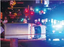  ?? JASON FRANSON/THE CANADIAN PRESS VIA AP ?? A U-Haul truck rests on its side after a high-speed chase with police in Edmonton on Sept. 30. Kim O’Hara, who was injured in the apparent attack, remains in hospital.