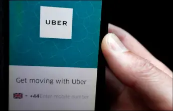  ??  ?? In this Sept. 22 file photo, an Uber App is displayed on a phone in London. Britain’s Employment Appeal Tribunal on Friday7 ruled that drivers of the ride-hailing service Uber are entitled to basic protection­s such as a guaranteed minimum wage and paid...