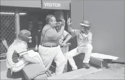  ?? ASSOCIATED PRESS ?? New Jersey Gov. Chris Christie high-fives Jake Espinoza on Sunday before Christie threw out a ceremonial first pitch before the Little League World Series Championsh­ip baseball game.