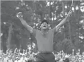  ??  ?? Tiger Woods celebrates after making a putt on the 18th green to win the Masters golf tournament at Augusta National Golf Club.