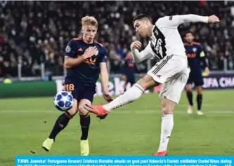  ??  ?? TURIN: Juventus’ Portuguese forward Cristiano Ronaldo shoots on goal past Valencia’s Danish midfielder Daniel Wass during the UEFA Champions League group H football match Juventus vs Valence on Tuesday at the Juventus stadium in Turin. —AFP