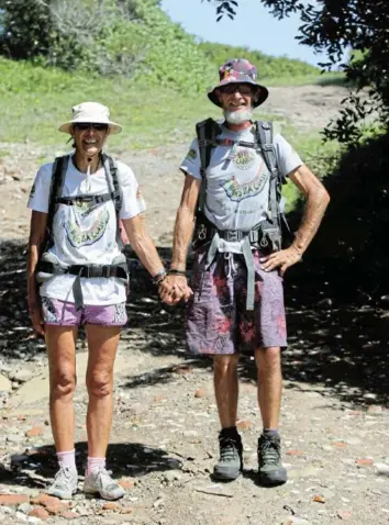  ?? Pictures: MICHAEL PINYANA ?? HAPPY TRAILS: Husband and wife Ian and Leanne Louw enjoy the surroundin­gs as they walk past East London on their epic, long-distance beach adventure:
