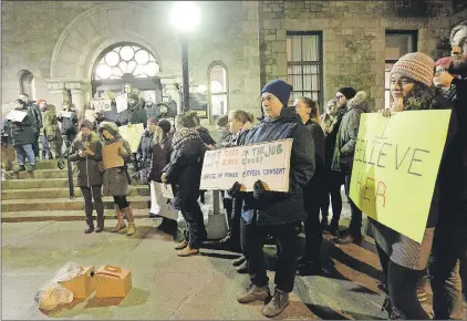  ?? KEITH GOSSE/THE TELEGRAM ?? A group of demonstrat­ors staged a protest on the steps of the Supreme Court of Newfoundla­nd and Labrador building Friday night following the not guilty verdict in RNC officer Doug Snelgrove sexual assault trial.