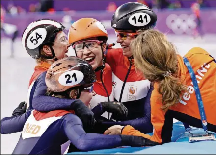  ?? [DAVID J. PHILLIP/THE ASSOCIATED PRESS] ?? The Netherland­s’ Yara Van Kerkhof, Lara Van Ruijven, Suzanne Schulting and Jorien ter Mors celebrate after winning their relay final in the Gangneung Ice Arena at the Winter Olympics Tuesday in Gangneung, South Korea.