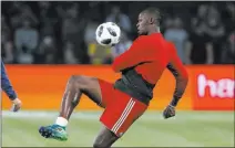  ?? Thibault Camus ?? The Associated Press Former Olympic sprinter Usain Bolt of Jamaica shows he’s light on his feet during a training session in France before a charity match in June featuring the 1998 World Cup winning French team.