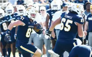  ?? STAFF PHOTO BY ROBIN RUDD ?? UTC's Jay Gibson, left, follows the blocking of Nick Cerimele on a screen pass during Saturday's SoCon game against Virginia Military Institute at Finley Stadium.