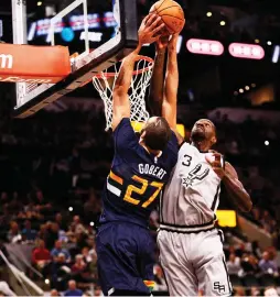  ?? (Reuters) ?? SAN ANTONIO SPURS defender Dewayne Dedmon (right) blocks a shot attempt by Utah Jazz center Rudy Gobert (27) during the first half of the Spurs’ 109-103 home victory over the Jazz on Sunday night.