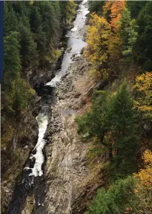  ??  ?? THIS PAGE:
Ottauquech­ee river at Quechee Gorge Vermont in the Fall; Late afternoon rural village stores