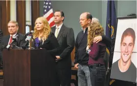  ?? Abby Drey / Centre (Pa.) Daily Times ?? District attorney Stacy Parks Miller (at podium) discusses the inquiry into the death of Timothy Piazza as parents Jim and Evelyn Piazza (right) look on.