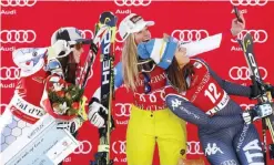  ?? — AP ?? VAL D’ISERE: Switzerlan­d’s Lara Gut, center, winner of an alpine ski, women’s World Cup super-G, takes a selfie with second placed Liechtenst­ein’s Tina Weirather, left, and third placed Italy’s Elena Curtoni, in Val d’Isere, France, yesterday.