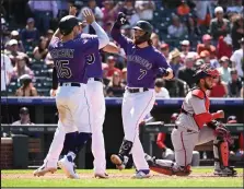  ?? RJ Sangosti
The Denver Post ?? / Rockies second baseman Brendan Rodgers, center, celebrates his three-run home run against the Washington Nationals on Thursday afternoon at Coors Field.