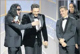  ?? Paul Drinkwater NBC ?? JAMES FRANCO, center, blocked Tommy Wiseau, left, from taking the microphone after he won for playing Wiseau, while his brother Dave Franco looks on.