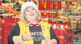  ?? JIM DAY/SALTWIRE NETWORK ?? Walmart greeter Sue Pitre belts out “Jingle Bell Rock” to the delight of customers making their way around the store during the busy Christmas season.