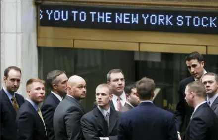  ?? THE ASSOCIATED PRESS ?? Businessme­n arrive at the New York Stock Exchange in New York on March 9, 2009. It was on that date that stocks finally hit bottom in the financial crisis, after the Standard & Poor’s 500 index lost 55 percent in 17 months and gutted retirement and...