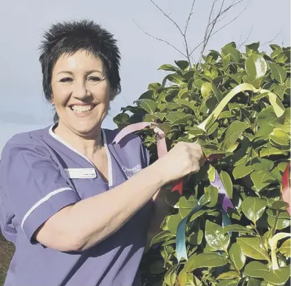  ??  ?? CHARITY: Staff show their support for Overgate Hospice’s ‘Rainbow of Ribbons’ campaign.