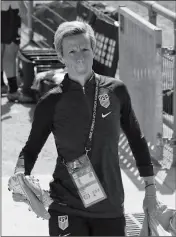  ?? ASSOCIATED PRESS ?? UNITED STATES’ Megan Rapinoe holds her shoes as she arrives for a training session at the Gymnase Parc des Sports in Limonest, outside Lyon, France, a day before their Women’s World Cup final match against the Netherland­s, Saturday.