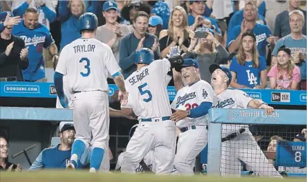  ?? Gina Ferazzi Los Angeles Times ?? COREY SEAGER, returning to the dugout after his second home run against the Giants on July 28, at 23 is one of the team’s young stars.