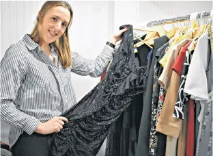  ?? DESIREE ANSTEY/JOURNAL PIONEER ?? Shawna Perry prepares her consignmen­t store items for the Little Black Dress Co. that will open early Feb.