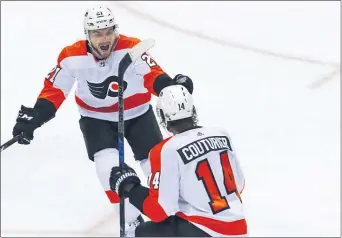  ?? THE ASSOCIATED PRESS FILE ?? Flyers winger Scott Laughton, left here celebratin­g a goal by scorer Sean Couturier, came into his own this season and is predicting the Flyers can do the same in the upcoming modified NHL postseason.