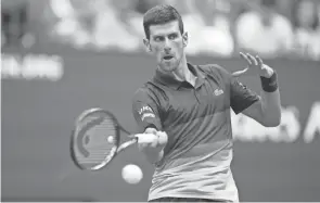  ?? DANIELLE PARHIZKARA­N/USA TODAY SPORTS ?? Novak Djokovic hits a forehand return against Daniil Medvedev in their U.S. Open final Sunday. Djokovic lost 6-4, 6-4, 6-4.