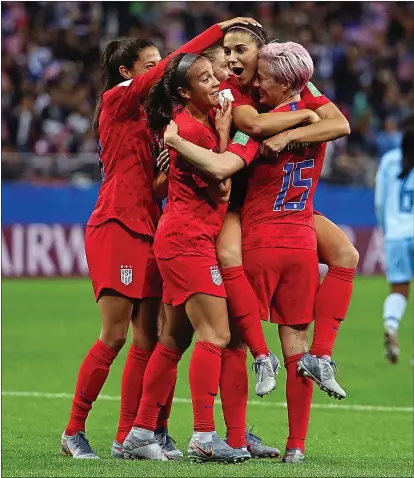  ?? ROBERT CIANFLONE – GETTY IMAGES ?? Alex Morgan, second from right, celebrates with her U.S. teammates after scoring her fifth goal and the team’s 12th against Thailand.