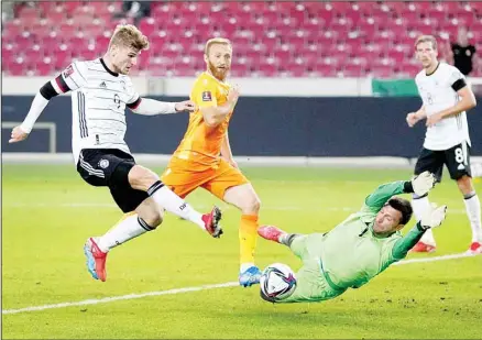  ??  ?? Germany’s Timo Werner, (left), scores his side’s fourth goal during the World Cup 2022 Group J qualifying soccer match between Germany and Armenia at Mercedes-Benz Arena stadium in Stuttgart, Germany. (AP)