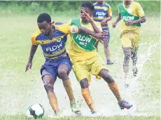  ??  ?? Ruseas High’s Ornell Forbes (left) and Knockalva High’s Trey Tomlinson (right) battle for the ball during their first-round ISSAFLOW daCosta Cup match at Rusea’s High earlier this season. Rusea’s won the game 3-0.