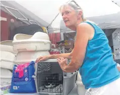  ?? [AP PHOTO] ?? Bonnie Smith, 67, was thrilled Friday when she stopped by the Livingston, La., animal shelter and found Betsy, the family cat.