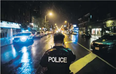  ??  ?? Police are seen around the scene of a shooting in east Toronto, on Monday. The parents of Faisal Hussain, whose shooting spree on Sunday in Toronto’s Greektown left two people dead and 13 injured, say their son had struggled all his life with psychosis...