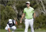  ?? MATT YORK — THE ASSOCIATED PRESS ?? Justin Thomas, right, smiles after saving par on the fourth green as Hideki Matsuyama places his ball on the green.